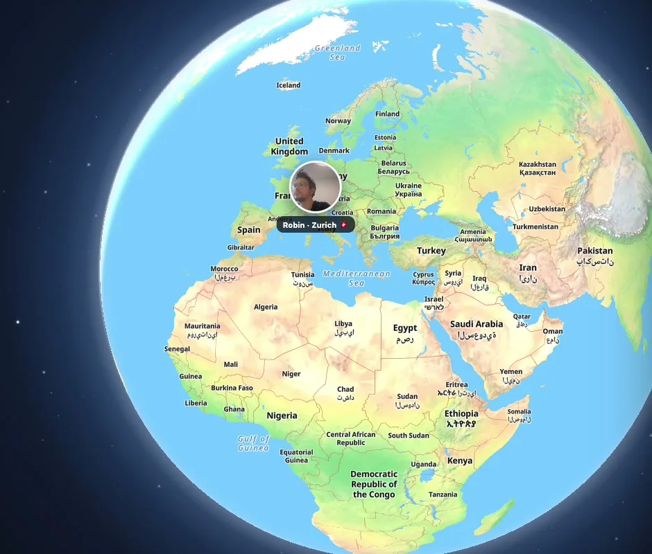 The globe inside no office, with a member working from Zurich